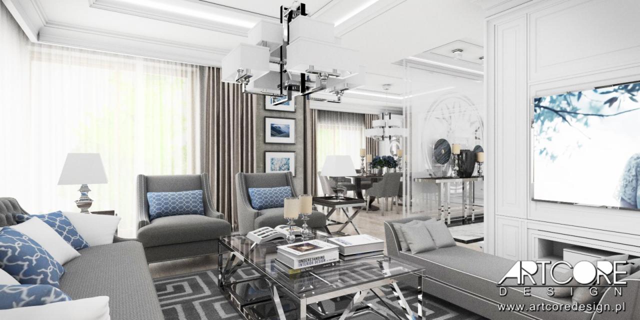 Elegancki salon w odcieniach szarości z akcentami błękitu, z nowoczesnym oświetleniem i szklanym stolikiem kawowym, widok na jadalnię w tle. Na ścianie wiszą oprawione grafiki.