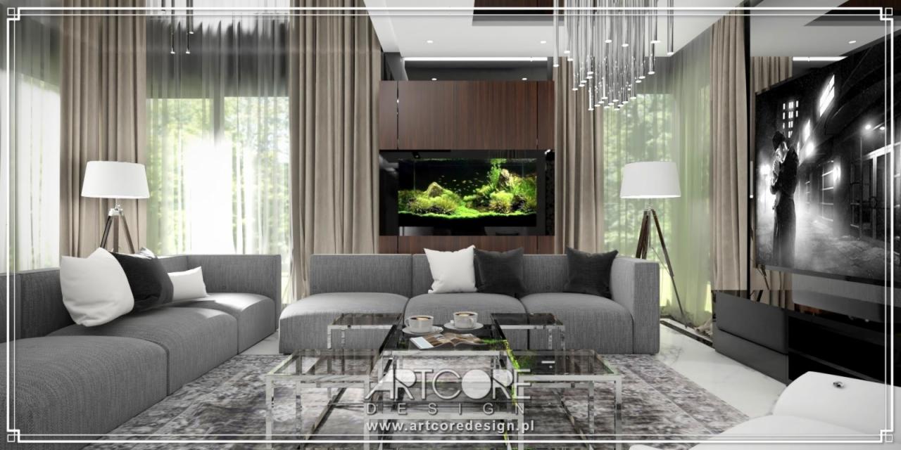 Nowoczesny salon w odcieniach szarości z akcentem w postaci akwarium w zabudowie meblowej, szklane stoliki kawowe i lampa podłogowa na trójnogu.