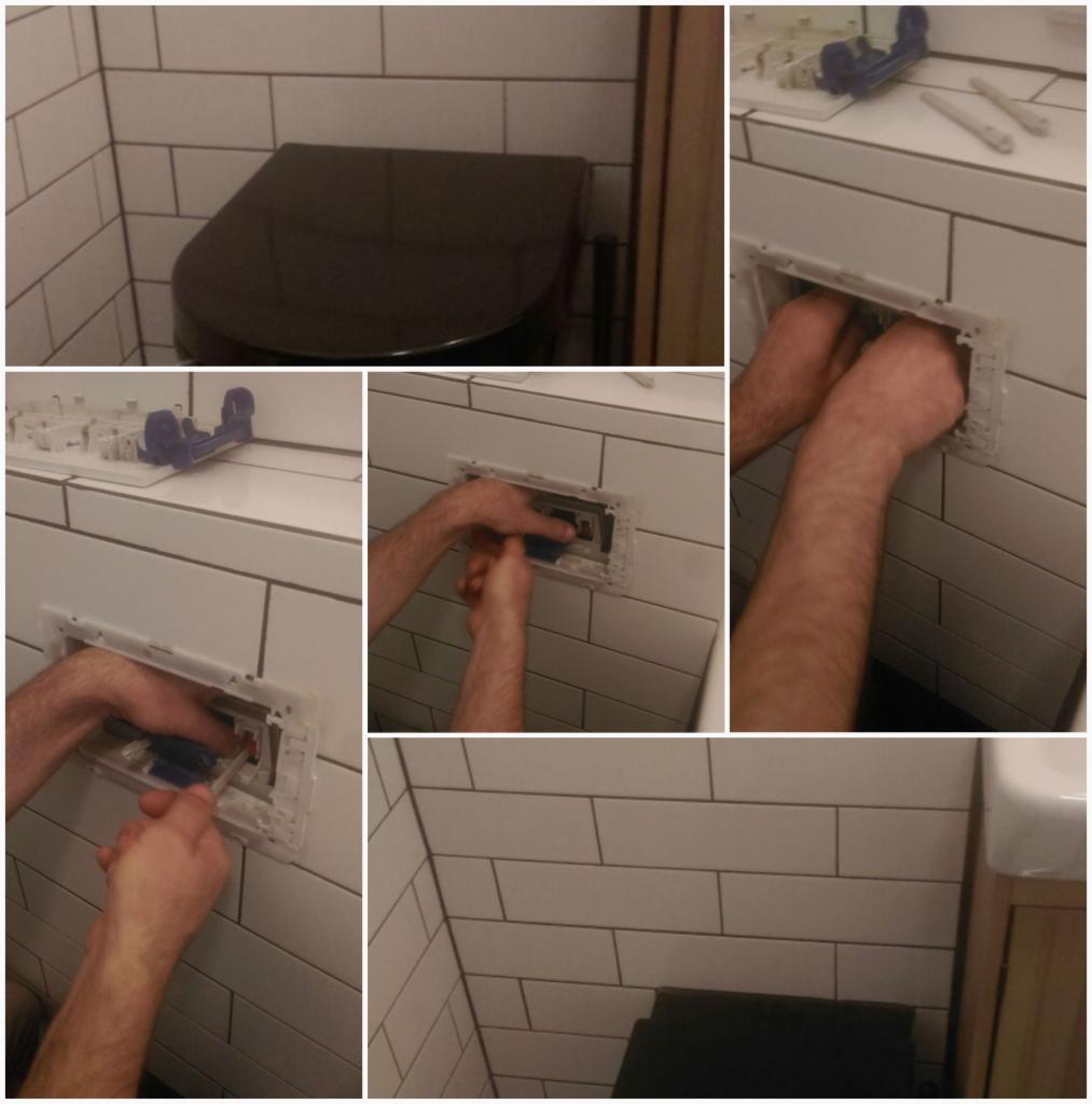 Instalacja podtynkowego systemu spłukiwania w toalecie z białymi płytkami; widoczne ręce instalatora, elementy systemu i czarna miska ustępowa w tle.