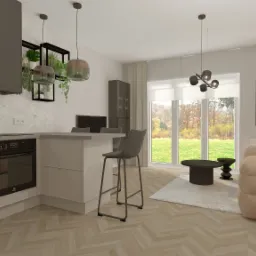 Wnętrze mieszkania z otwartą kuchnią, wyspą z hokerem, beżową sofą modułową i widokiem na ogród przez duże okno.