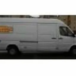 Biały samochód dostawczy Mercedes-Benz Sprinter z pomarańczowym logo firmy świadczącej usługi transportowe i przeprowadzkowe, zaparkowany na ulicy.