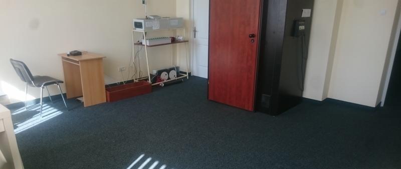 Gabinet w Gdyni z biurkiem, krzesłem i aparaturą na półkach, przygotowany do konsultacji.