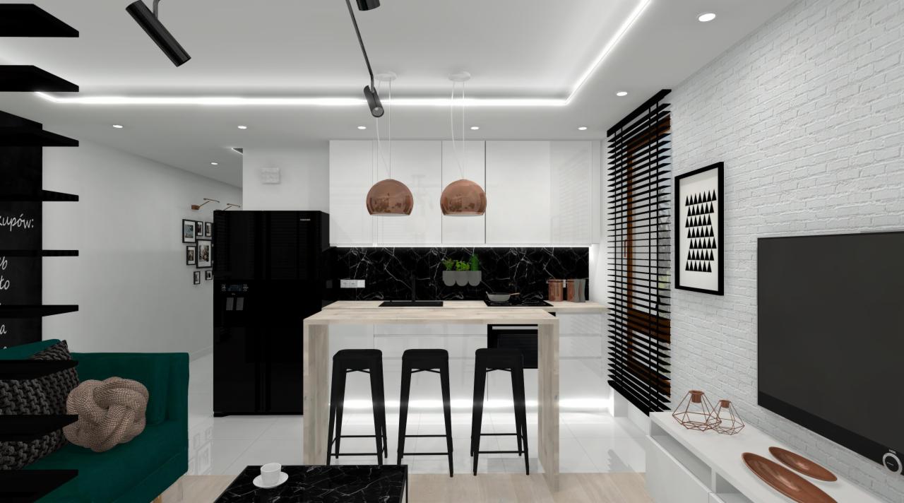 Wnętrze nowoczesnego mieszkania z aneksem kuchennym, wyspą z trzema hokerami, zieloną sofą i czarną lodówką, oświetlone lampami wiszącymi w kolorze miedzi.