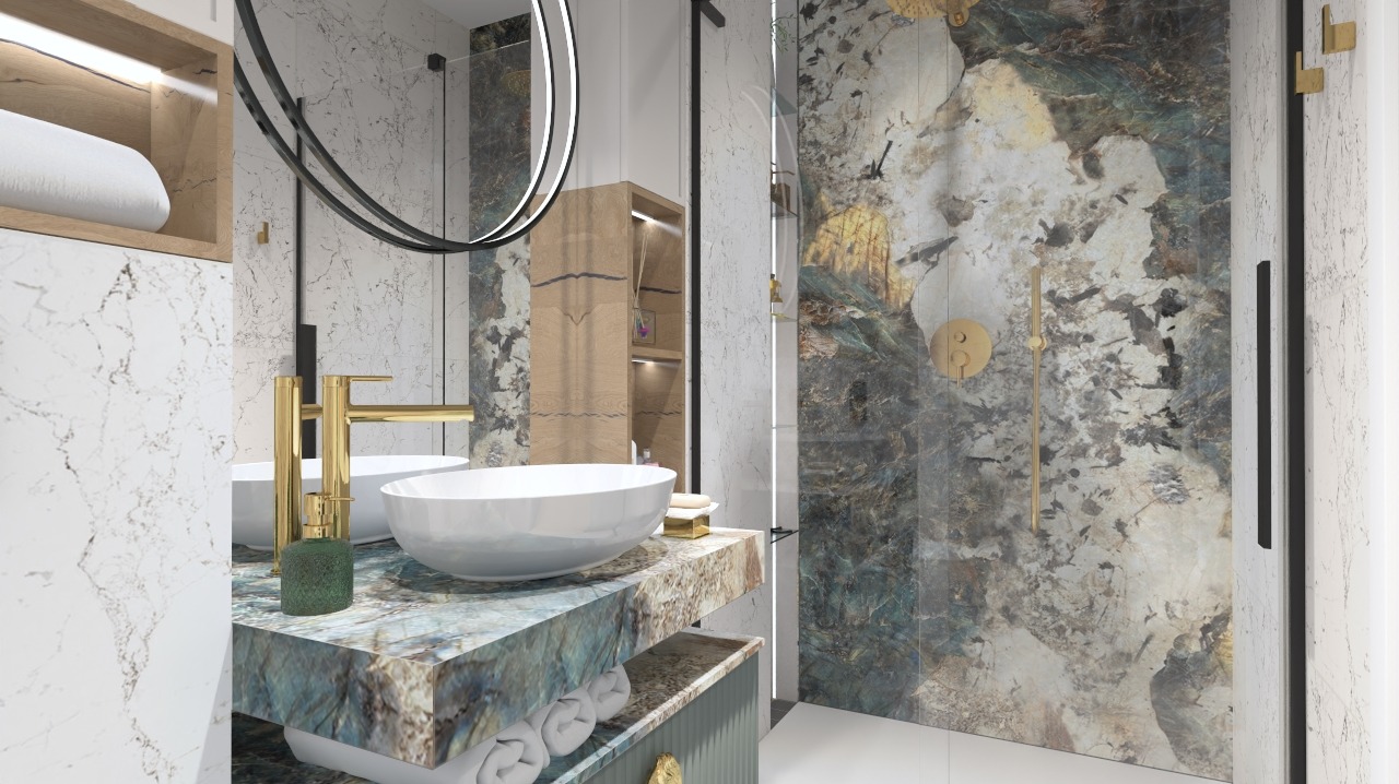 Nowoczesna łazienka z umywalkami nablatowymi, złota armatura i kabina prysznicowa z dekoracyjną okładziną imitującą kamień.