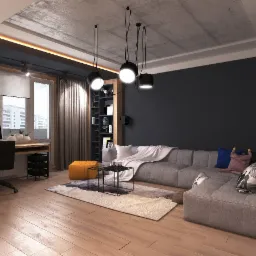 Wnętrze pokoju dziennego z biurkiem i szarą sofą modułową, oświetlenie sufitowe z trzema lampami wiszącymi, betonowy sufit i drewniana podłoga.