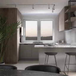 Nowoczesna kuchnia z wyspą, marmurowym blatem i hokerami, oświetlenie punktowe na suficie, roślina doniczkowa w rogu pomieszczenia, widok na zewnątrz przez okno.