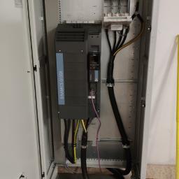 ZEUS Wire-Tech - Otwarta szafa sterownicza z zamontowanym falownikiem Siemens Sinamics G120X i okablowaniem, widoczne zabezpieczenia nad falownikiem i wentylator w drzwiach.