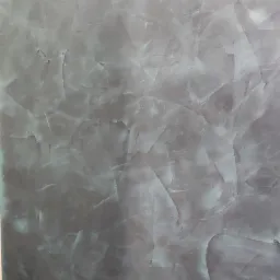 Dekoracyjna ściana w odcieniach szarości i błękitu z efektem marmuru, wykonana techniką stiuku weneckiego, prezentująca unikalny wzór i fakturę.