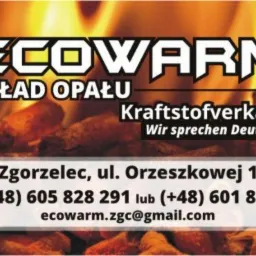 Reklama składu opału ECOWARM z Zgorzelca, prezentująca pellet na tle płomieni, z informacjami kontaktowymi i hasłem 'Wir sprechen Deutsch'.