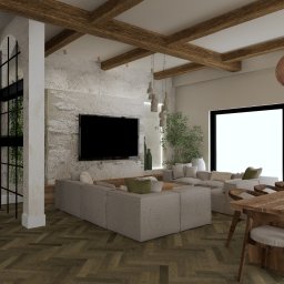 KRZYSZTOF BIELIK ARTCADE - STUDIO PROJEKTOWANIA WNĘTRZ - Wnętrze salonu z jadalnią w stylu rustykalnym: drewniane belki, kamienna ściana z TV, szara sofa modułowa i stół z krzesłami. Naturalne materiały i stonowana kolorystyka.