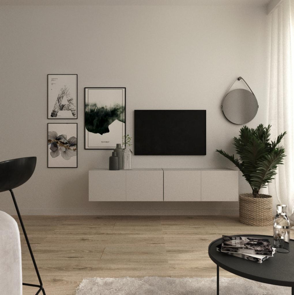 Minimalistyczny salon z wiszącą szafką RTV, czarnym telewizorem, okrągłym lustrem i trzema obrazami w czarnych ramkach, uzupełniony rośliną w plecionym koszu i stolikiem kawowym z magazynami.