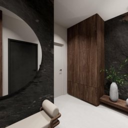 Dolecińska Projekt DARIA DOLECIŃSKA - Nowoczesny przedpokój z elementami drewna i kamienia, okrągłe lustro z czarną ramą, minimalistyczna ławka i oświetlenie. Projekt z dbałością o detale i spójność kolorystyczną.