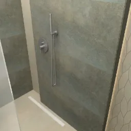 Nowoczesna łazienka z kabiną prysznicową walk-in, szarozielone płytki imitujące kamień na ścianie, minimalistyczna armatura i dekoracyjna ściana z geometrycznym wzorem w odcieniach beżu.