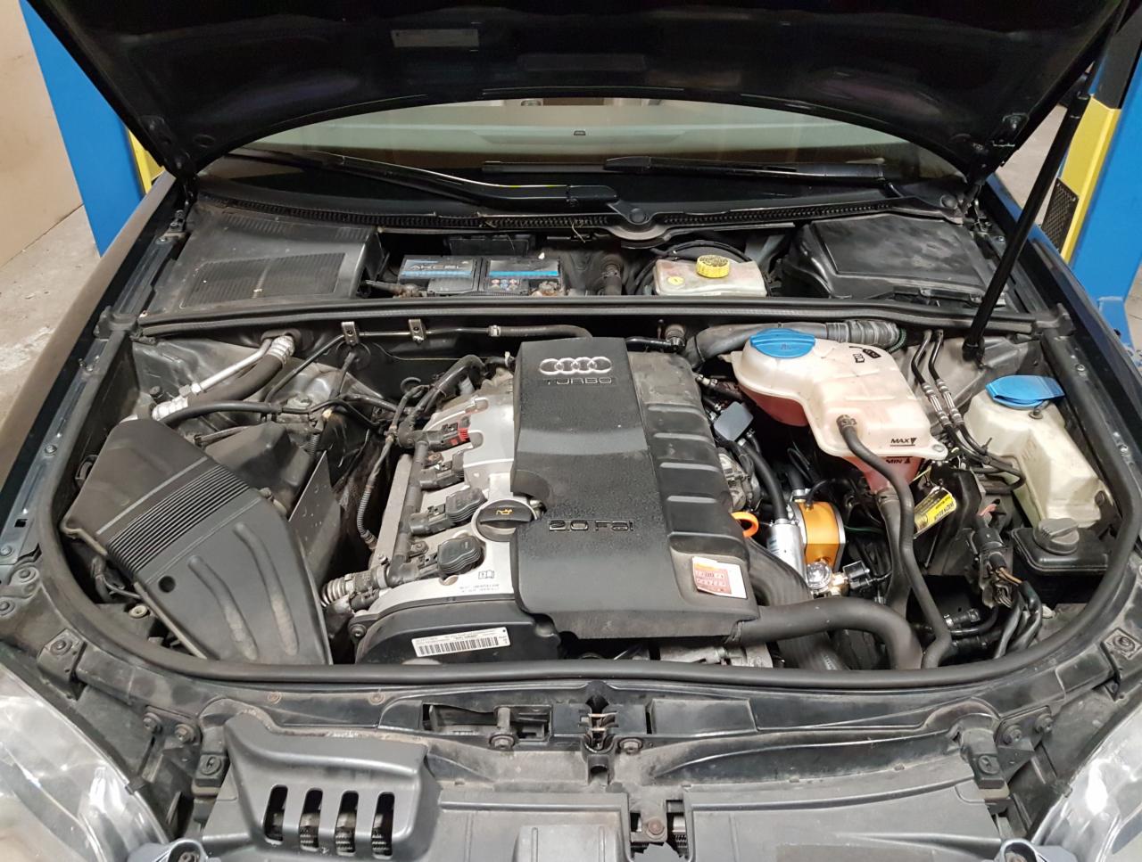 Silnik Audi z widoczną instalacją LPG, żółty reduktor w komorze silnika, otwarty przedni panel.