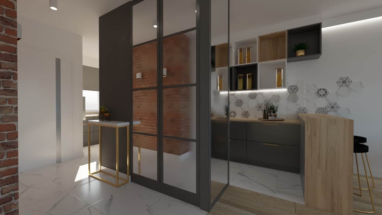 Wnętrze mieszkania z przeszkloną ścianą działową w stylu loft, oddzielającą kuchnię z szarymi szafkami i drewnianym barkiem od części wejściowej z ceglaną ścianą i marmurową podłogą.