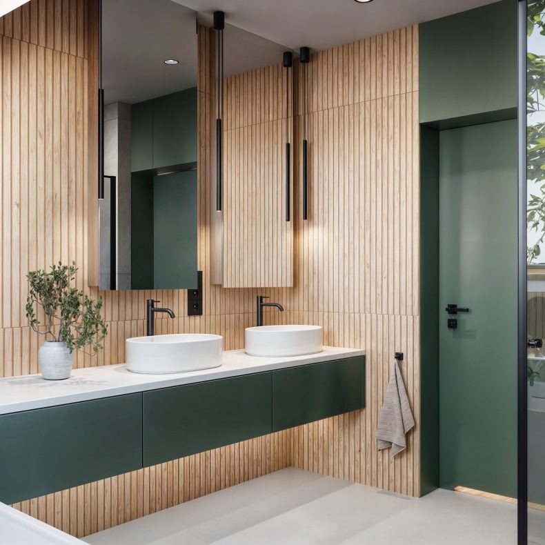 Nowoczesna łazienka z dwiema umywalkami na blacie w kolorze zieleni, drewniane panele na ścianach i minimalistyczne oświetlenie.
