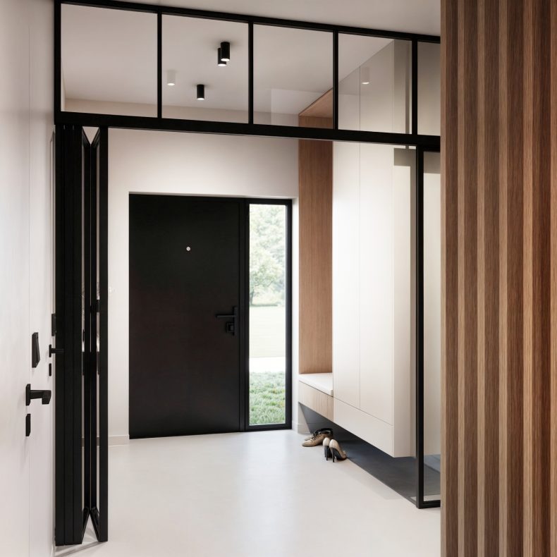 Nowoczesny hol w Skierniewicach: czarne drzwi wejściowe, białe ściany, drewniane panele dekoracyjne i minimalistyczne oświetlenie sufitowe.