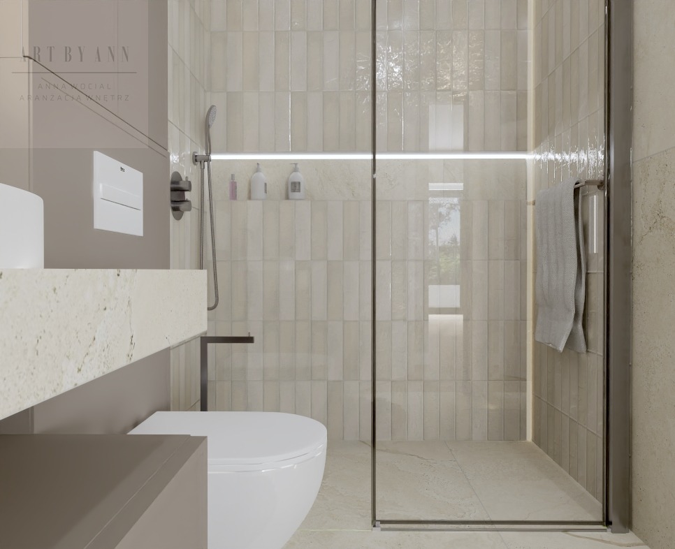 Nowoczesna łazienka z beżowymi płytkami, szklaną kabiną prysznicową i minimalistyczną umywalką. Oświetlenie LED podkreśla subtelny design.