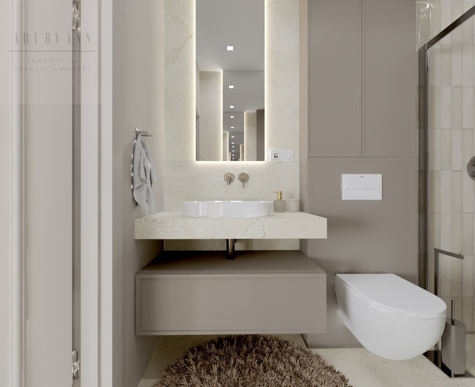 Nowoczesna łazienka w beżach: podświetlane lustro, umywalka nablatowa, wisząca toaleta i szafka pod umywalką z dywanikiem. Minimalistyczny design z dbałością o detale.