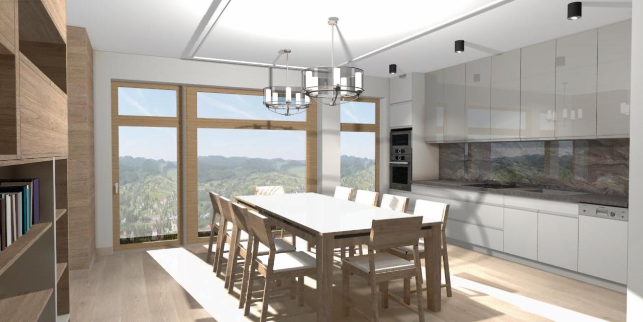 Wizualizacja przestronnej jadalni z dużym oknem z widokiem na góry, białymi szafkami kuchennymi i drewnianym regałem na książki, oświetlona dwoma nowoczesnymi żyrandolami.