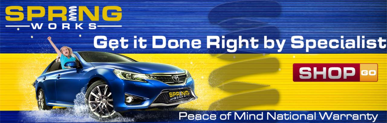 Niebieski samochód osobowy marki Toyota z logiem Spring Works na tle grafiki w odcieniach niebieskiego i żółtego, z hasłem reklamowym 'Get it Done Right by Specialist' i logiem 'SHOP GO'. W oknie...