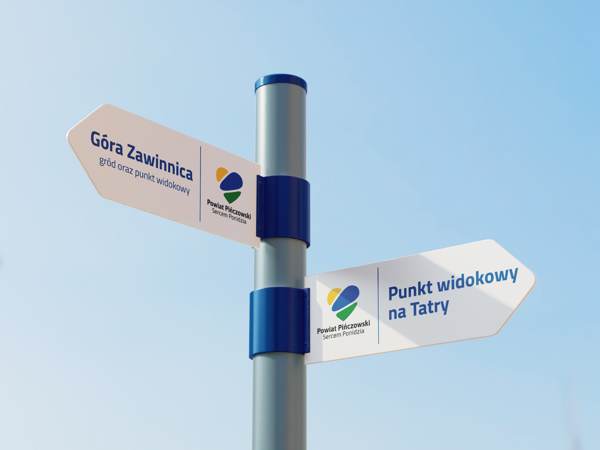 Drogowskaz turystyczny z dwoma strzałkami wskazującymi kierunki: Góra Zawinnica i Punkt widokowy na Tatry, z logo Powiatu Pińczowskiego na tle błękitnego nieba.