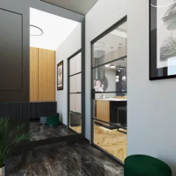 Wnętrze domu z marmurową podłogą, czarną konsolą z rośliną w srebrnej doniczce, widokiem na kuchnię przez szklane drzwi w czarnej ramie i obrazem na ścianie.