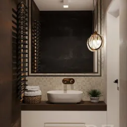 Nowoczesna łazienka z umywalką nablatową, mozaiką na ścianie, wiszącą lampą z elementami złota i grzejnikiem drabinkowym na ręczniki, w neutralnej kolorystyce.