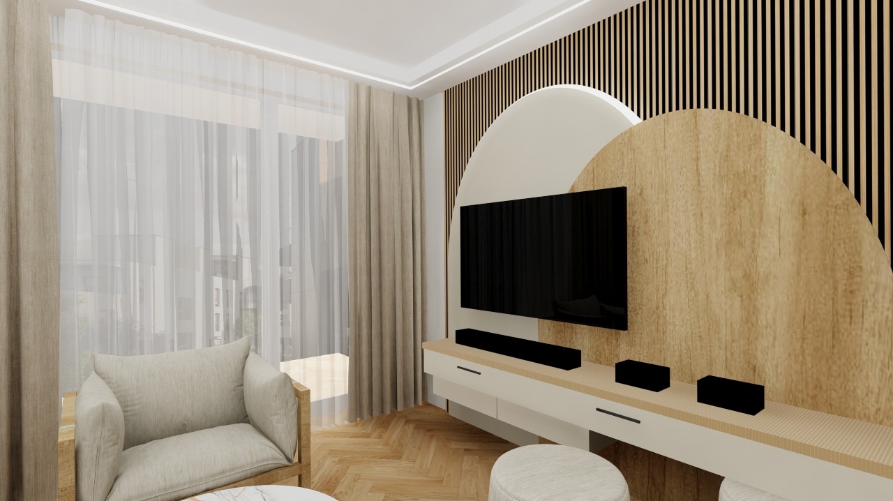 Jasne wnętrze salonu z drewnianą ścianą dekoracyjną, telewizorem i beżowym fotelem. Parkiet w jodełkę, okno z firanami. Nowoczesny design.