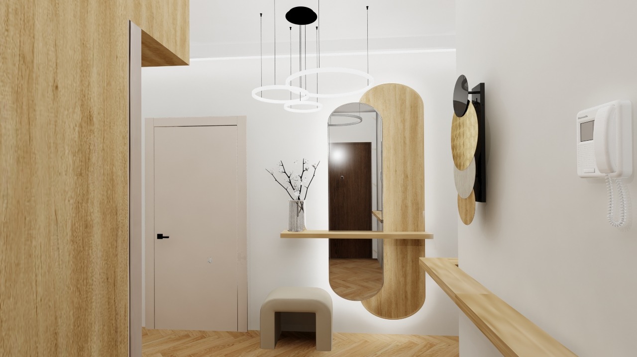 Nowoczesny przedpokój w jasnych barwach z drewnianymi akcentami. Lustro w kształcie łuku, designerska lampa i minimalistyczne dodatki tworzą spójną całość.