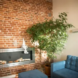 Wnętrze pokoju z ceglaną ścianą, nowoczesnym kominkiem z metalową ramą, na którym siedzi pluszowy skrzat, obok stoi roślina w doniczce i niebieska sofa.