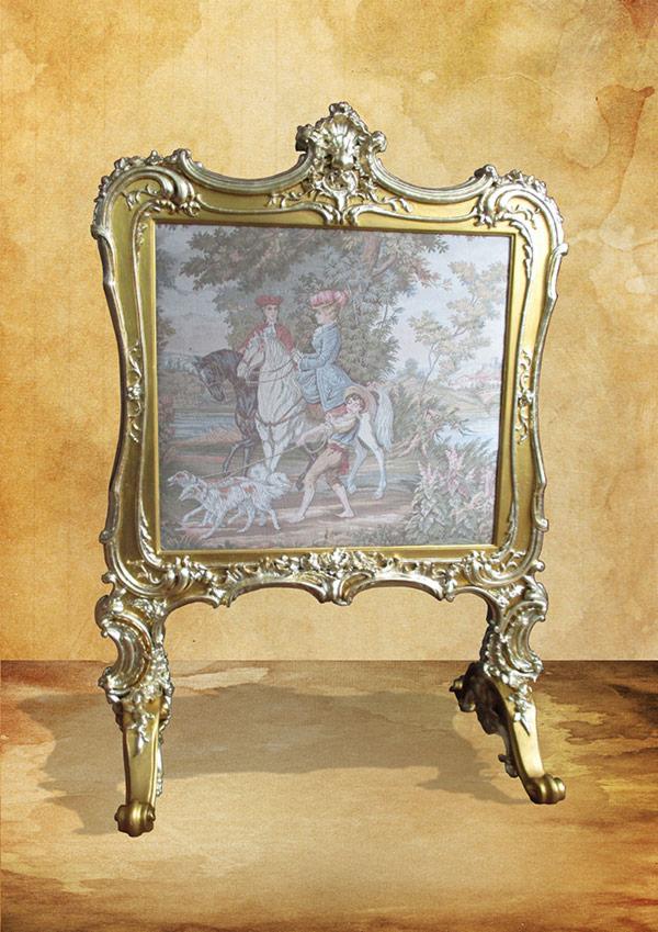 Złota, bogato zdobiona rama z gobelinem przedstawiającym scenę polowania z postaciami na koniach i psami gończymi.