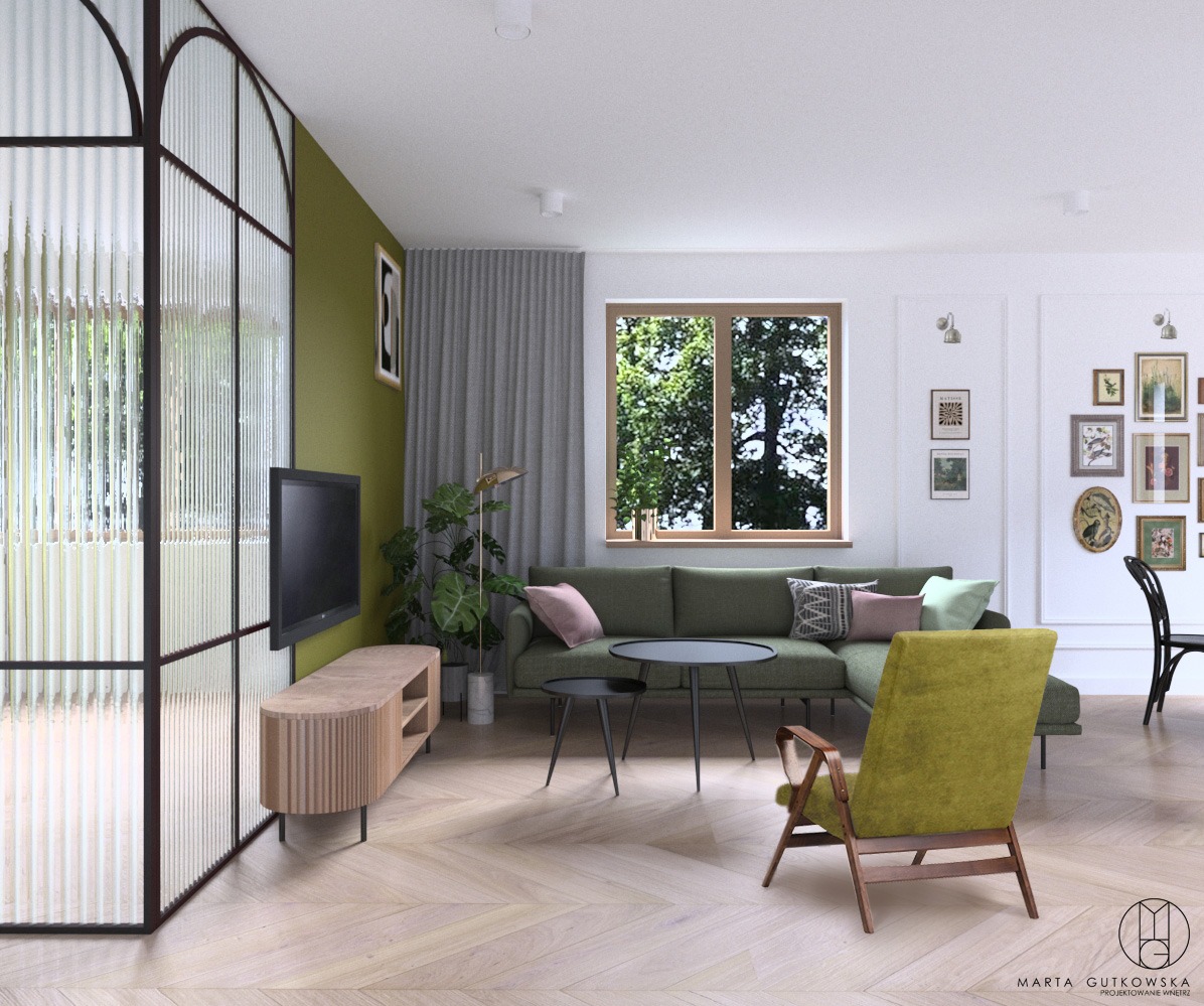 Wnętrze salonu z zieloną sofą narożną, stolikiem kawowym, telewizorem na komodzie z lamelami, oraz ścianką działową ze szkła ryflowanego w czarnej ramie, na podłodze parkiet w jodełkę.
