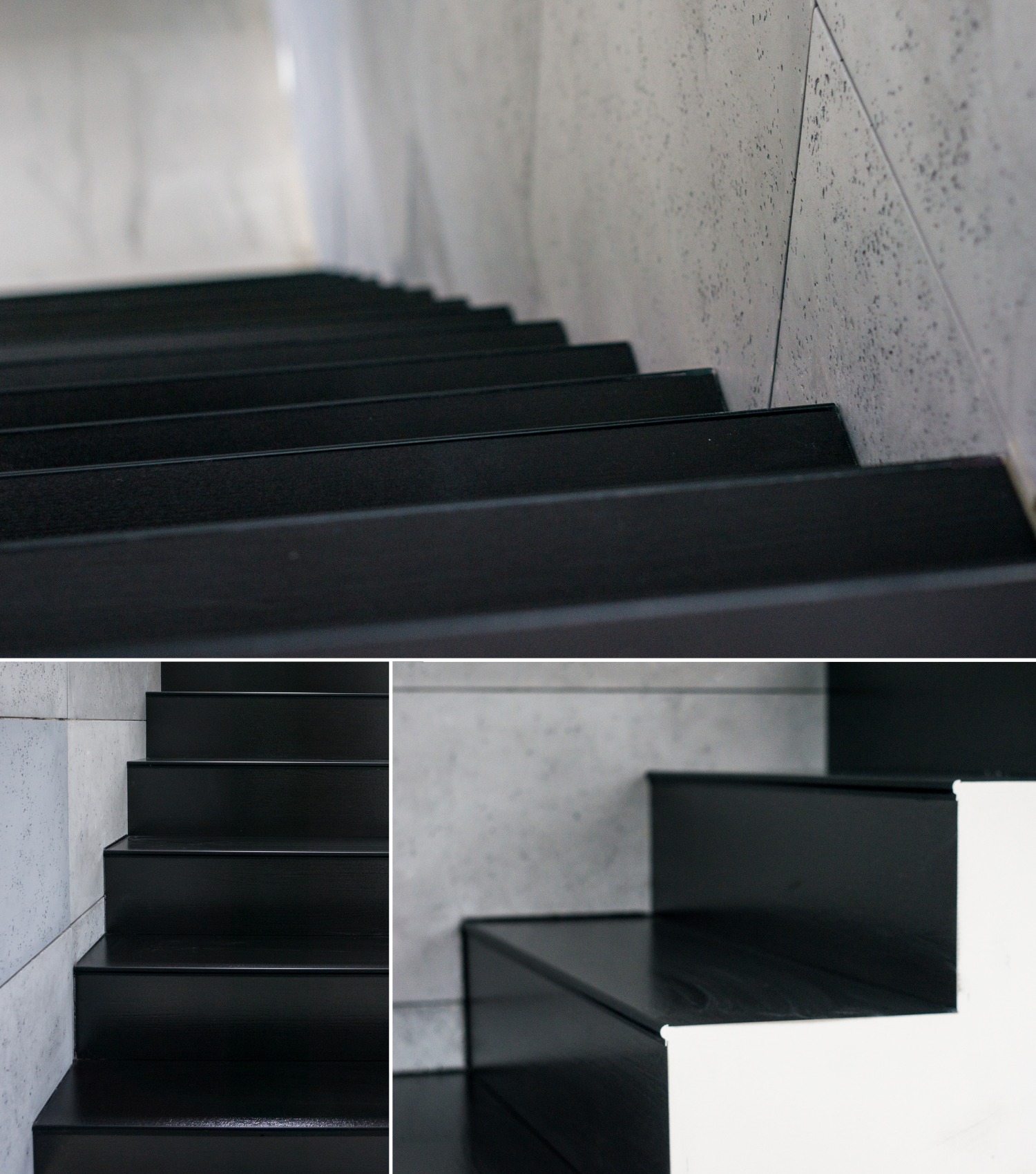 Nowoczesne schody z czarnymi stopniami i szarą, kamienną okładziną ściany, widoczne z bliska, z delikatnym oświetleniem.
