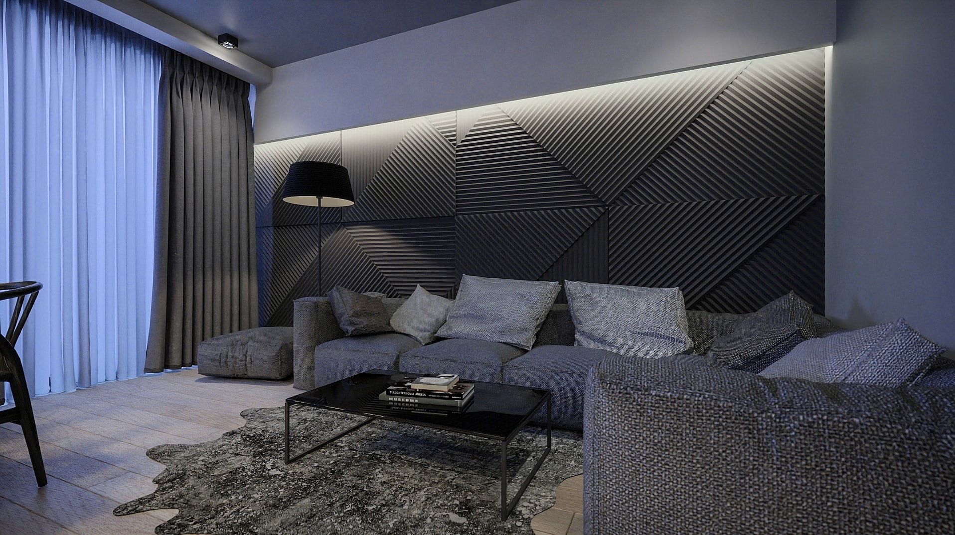 Nowoczesny salon z szarą modułową sofą, geometryczną ścianą z podświetleniem LED, czarnym stolikiem kawowym z książkami i dywanem o nieregularnym kształcie.