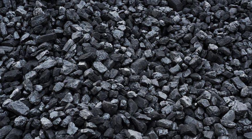 Góra czarnego węgla kamiennego, różne rozmiary brył, matowa powierzchnia z miejscowymi refleksami światła.