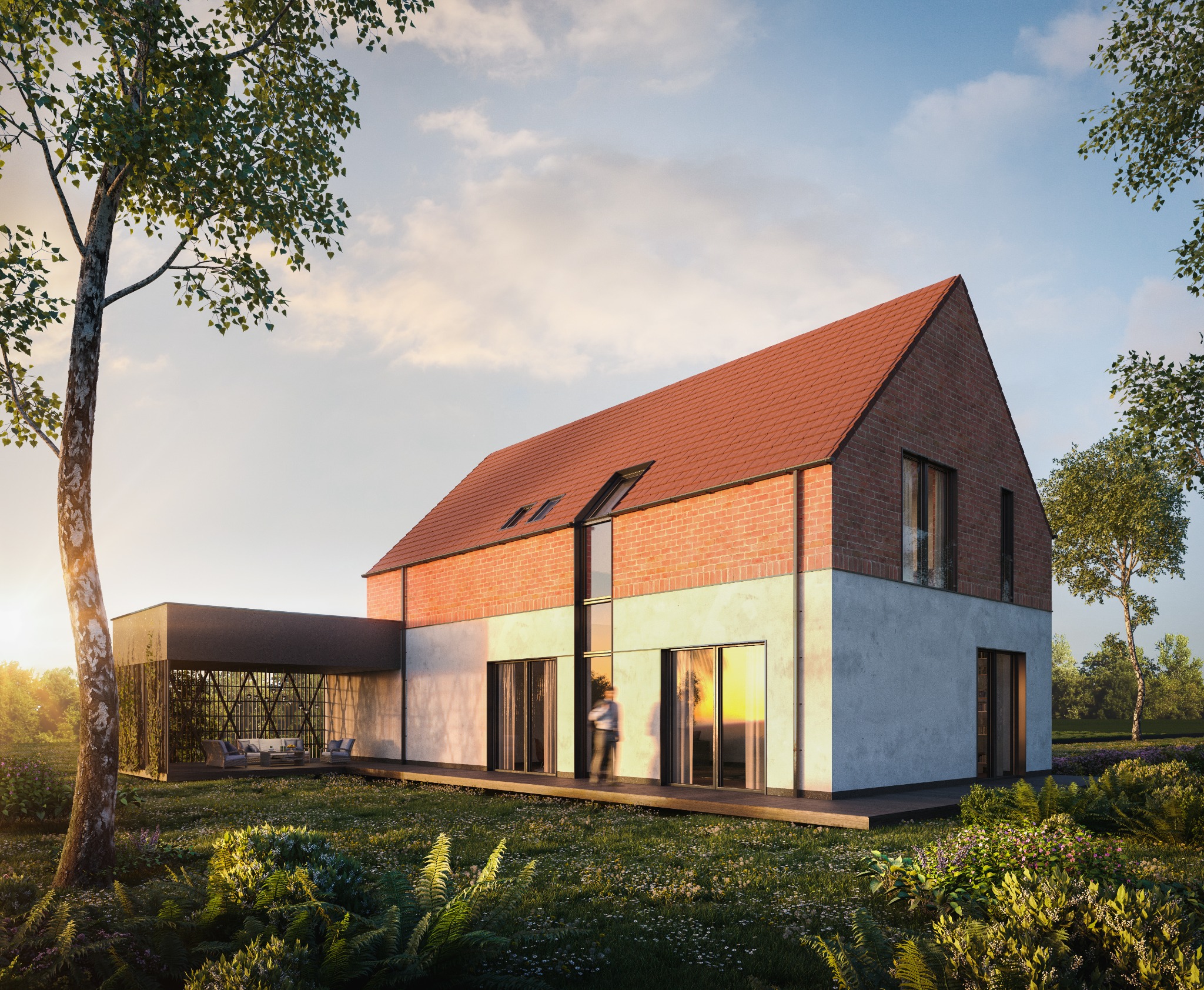 Nowoczesny dom z ceglaną górą i jasną elewacją, otoczony bujną zielenią, z zadaszonym tarasem i osobą w tle.