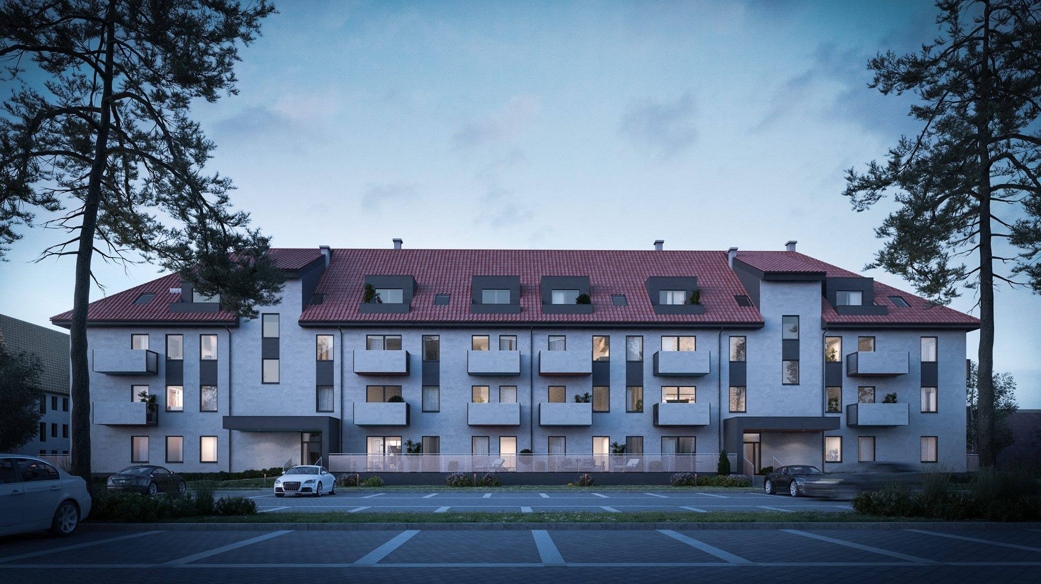 Wizualizacja elewacji budynku wielorodzinnego z balkonami, czerwonym dachem i parkingiem przed budynkiem, ujęcie wieczorne.