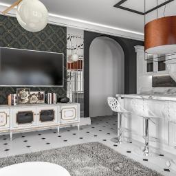 YOR - Nowoczesne wnętrze: biała kuchnia z marmurowym blatem i transparentnymi krzesłami barowymi, salon z telewizorem na tle wzorzystej tapety, oświetlone wiszącą lampą.