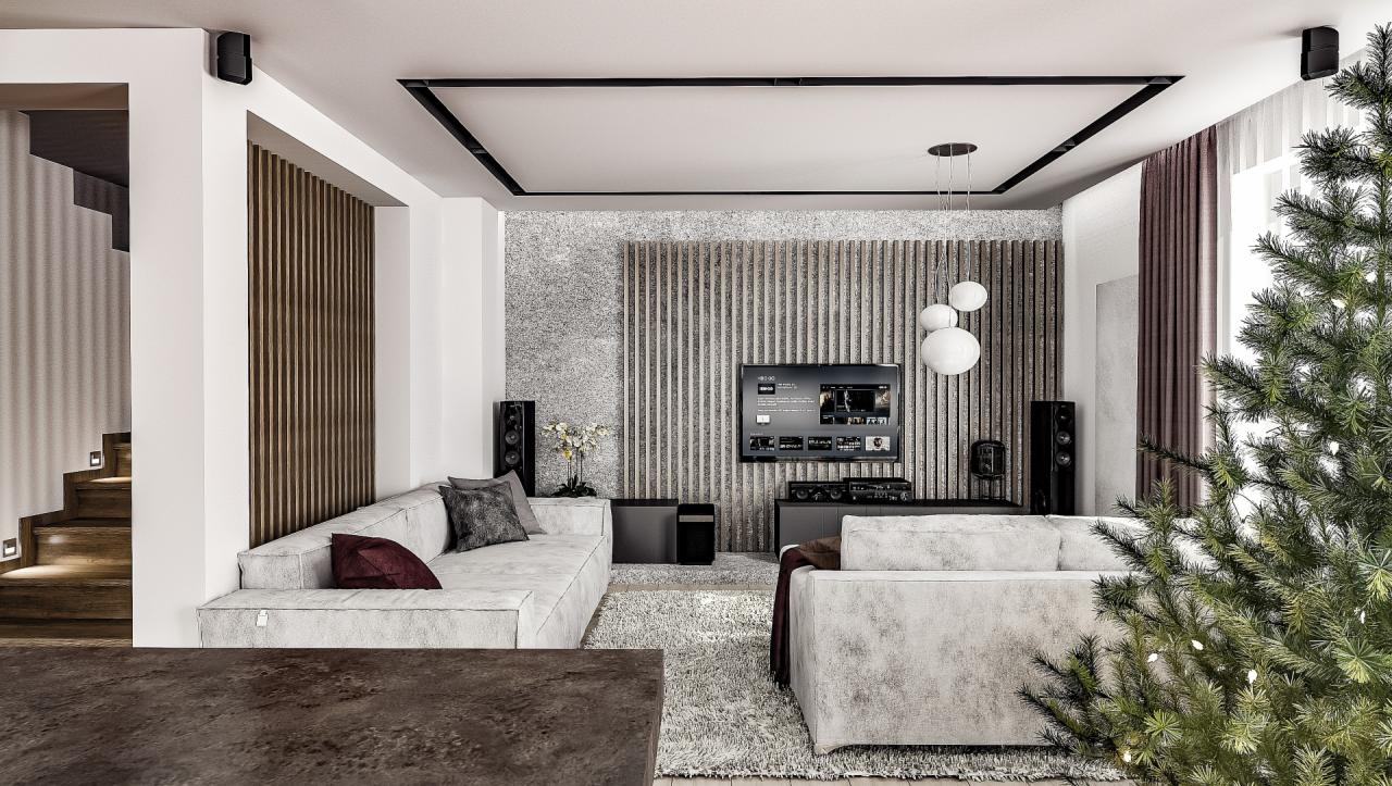 Nowoczesny salon z szarą sofą, telewizorem na ścianie z drewnianymi panelami i choinką w rogu.