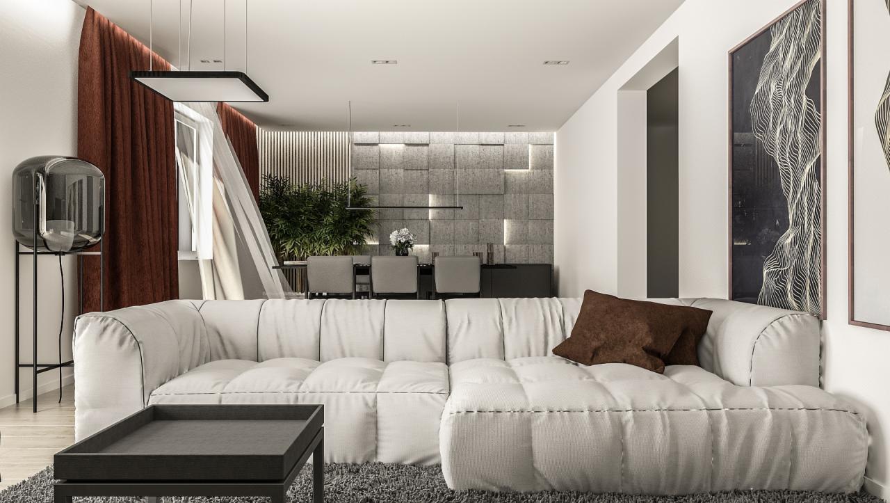 Nowoczesny salon z narożną sofą w odcieniach bieli, brązową poduszką, stolikiem kawowym na tle ściany z dekoracyjnych paneli i zasłon w kolorze rdzy.