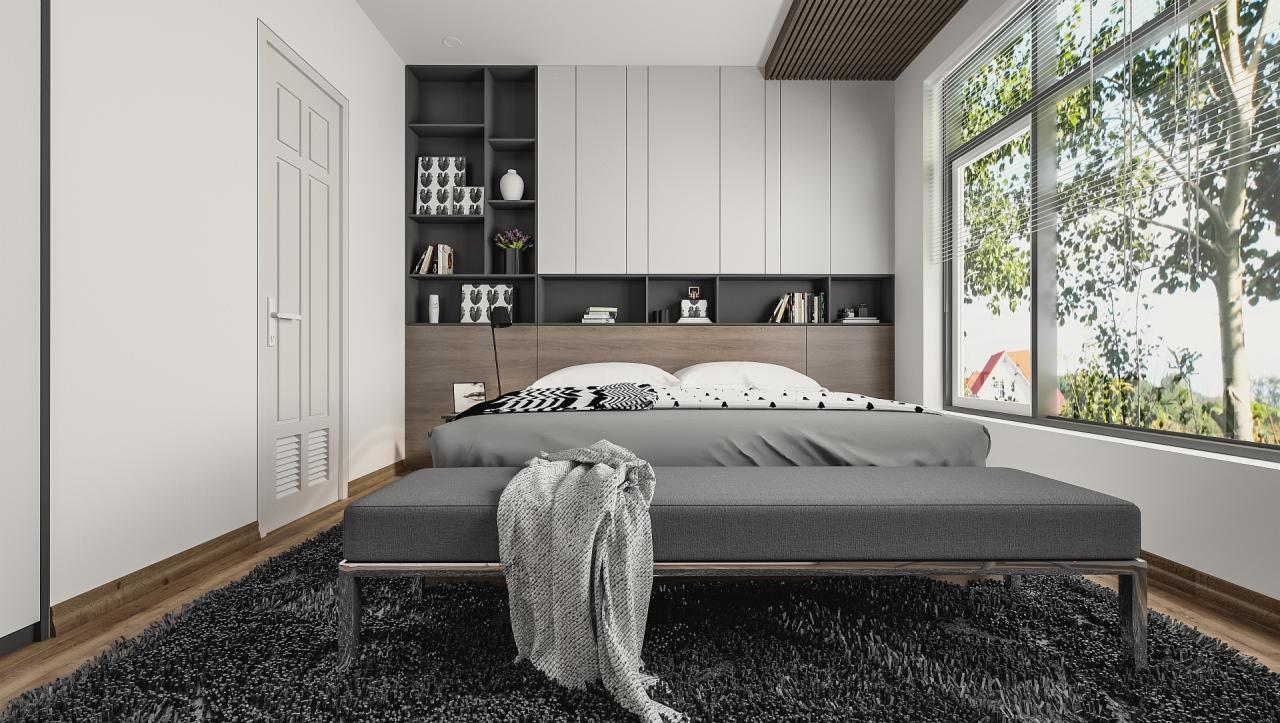 Nowoczesna sypialnia z łóżkiem, szarą narzutą i dywanem z długim włosiem, zabudową meblową z półkami i szafkami oraz dużym oknem z widokiem na zieleń.