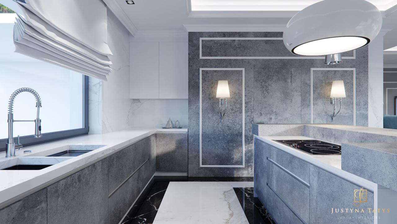 Nowoczesna kuchnia z szarymi szafkami, białym blatem i marmurową podłogą, oświetlona lampami ściennymi i okrągłą lampą sufitową.