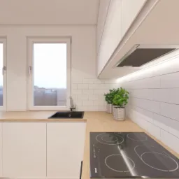 Jasna kuchnia z drewnianym blatem, białymi szafkami, czarnym zlewem i płytą indukcyjną, wykończona białymi płytkami w stylu metro, z roślinami w srebrnych doniczkach i parkietem w jodełkę na podłodze.