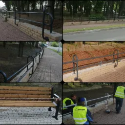 Montaż metalowej poręczy na niskim murku z cegły klinkierowej wzdłuż chodnika w parku, widoczni pracownicy w kamizelkach odblaskowych podczas instalacji, narzędzia pracy na chodniku.