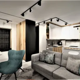 Wizualizacja wnętrza mieszkania: salon z szarą sofą, turkusowym fotelem, aneksem kuchennym z drewnianymi akcentami i oświetleniem punktowym na szynach.