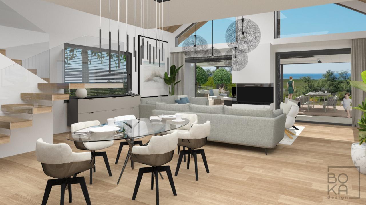 Wizualizacja przestronnego salonu z jadalnią: szklany stół, krzesła z beżową tapicerką, szara sofa narożna, schody z drewnianymi stopniami, widok na taras z ogrodem i morzem w tle.