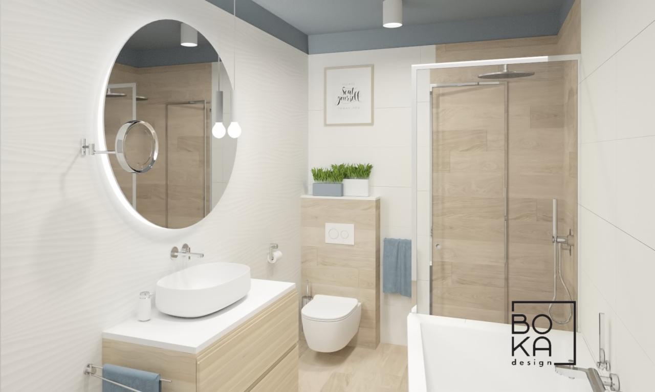Jasna łazienka z okrągłym lustrem podświetlanym LED, umywalką nablatową, toaletą podwieszaną i kabiną prysznicową typu walk-in z drewnopodobnymi płytkami.