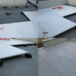 Montaż szarych płyt tarasowych na regulowanych wspornikach w Dobroniu, widoczne narzędzia poziomujące i fragment ukończonej powierzchni.