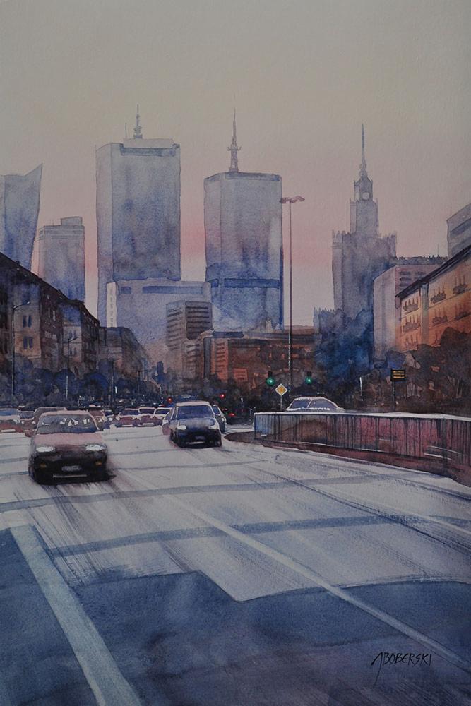 Akwarela przedstawiająca ruchliwą ulicę miasta z wieżowcami w tle, widzianą z perspektywy niskiego kąta, z wyraźnym podpisem artysty w prawym dolnym rogu.